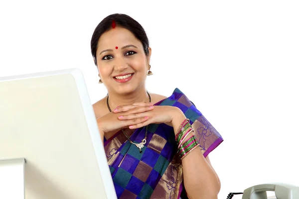 Happy traditional Indian business woman at office desk — Stock Photo, Image