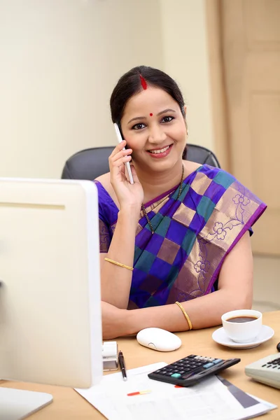 Traditional Indian business woman talking on mobile phone