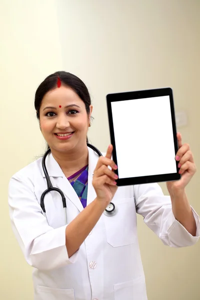 Young female doctor showing blank white screen tablet computer