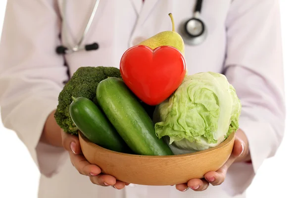 Closeup of doctor holding a bowl of vegetables against white bac — Stock Photo, Image