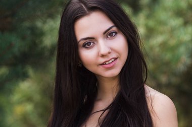 Zarif çekici esmer model iğne yapraklı Park siyah elbise poz