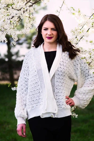 Fashionable spring clothes. Black dress and white sweater.