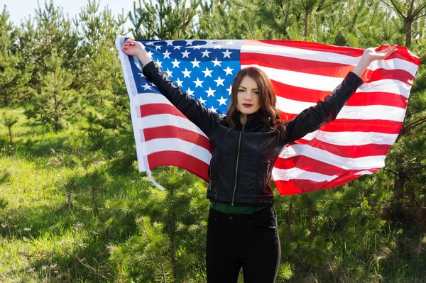 A young beautiful woman with a flag of the United States of America copy space