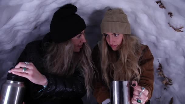 Twin Sisters Spilling Hot Chocolate While Snow Cave Stay Warm — Stock Video