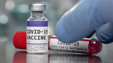 Covid-19 Coronavirus aşısı ve antikor şişesi yan yana yerleştirilmiş tıbbi laboratuvarda..