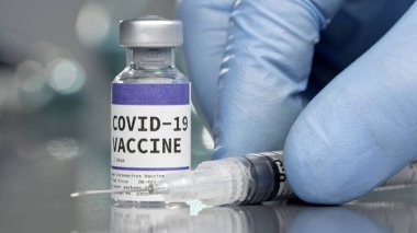Covid-19 Coronavirus aşı şişesi tıp laboratuarında şırıngayla