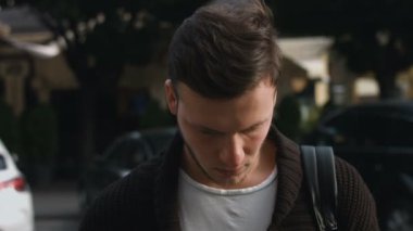 Kameraya bakarak ciddi bakışları ile çekici genç adam: 4 k görüntüleri