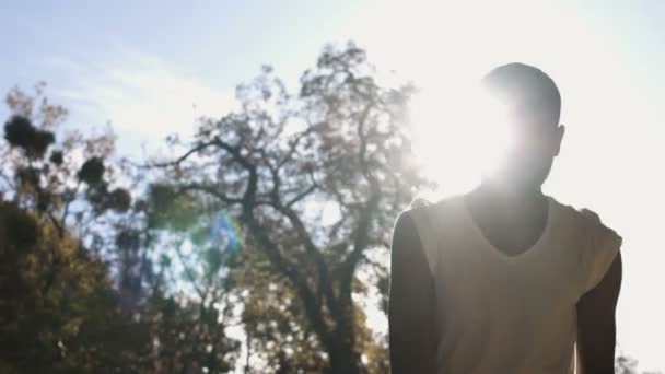 Boy shooting a ball outdoors in the evening — Stock video