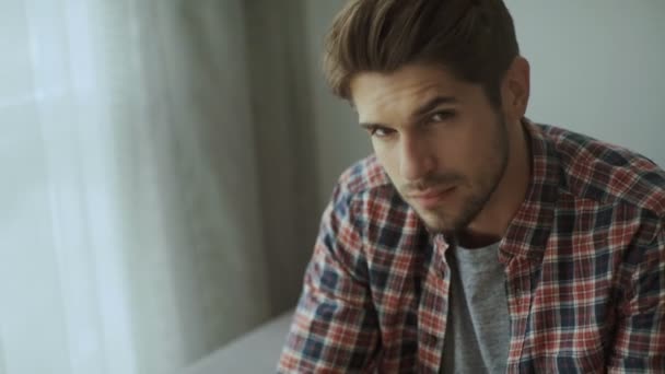 Feliz joven. Retrato de un joven guapo con camisa casual manteniendo los brazos cruzados y sonriendo — Vídeo de stock