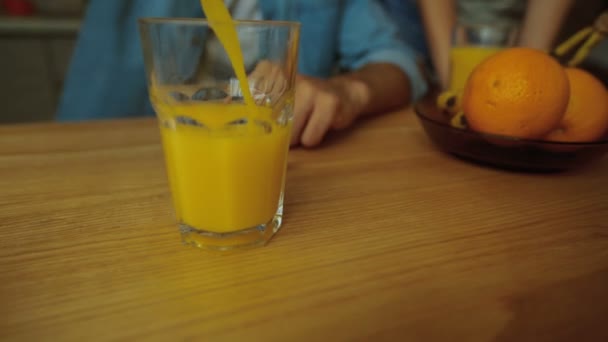 Pouring orange juice into glass shooting with high speed camera, — Stock video