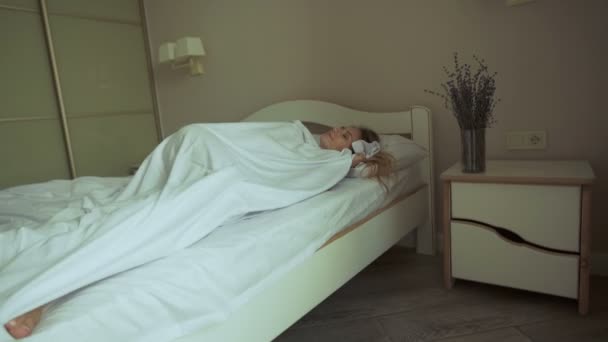 Fris en gelukkig vrouw in bed wordt wakker in de ochtend glimlachend — Stockvideo
