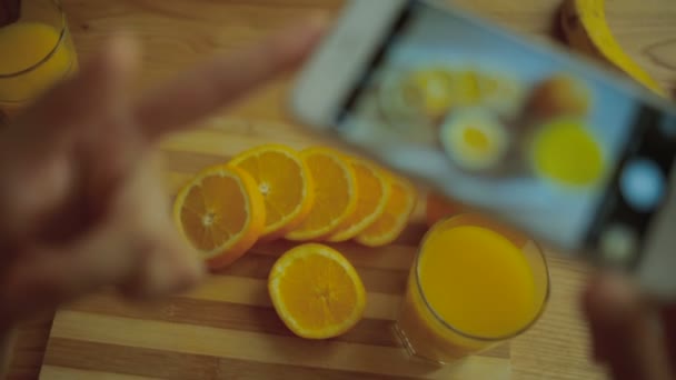 Pictures of orange and juice on mobile camera. — Stock video