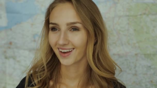 Young tourist woman portrait world map background — Stock video