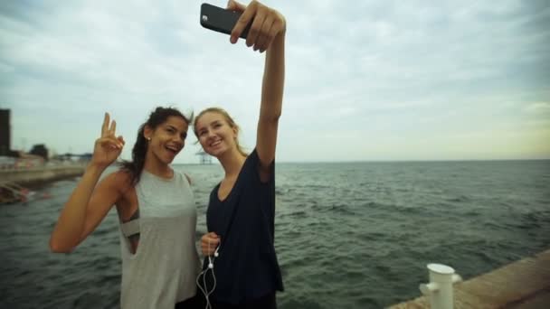 Young active ladies taking selfie after long morning jogging. — Stock video