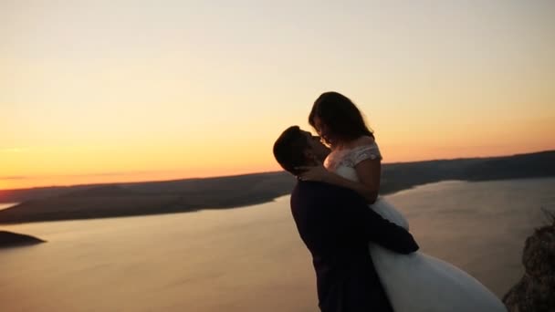 Loving couple holding hands , while watching beautiful sunset. — Stock Video