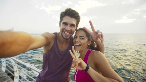 Funny couple taking pictures after long distance that they have run together.