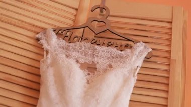 Güzel bir lüks gelinlik askı üzerinde ahşap arka plan üzerinde kapatın. Düğün hazırlığı