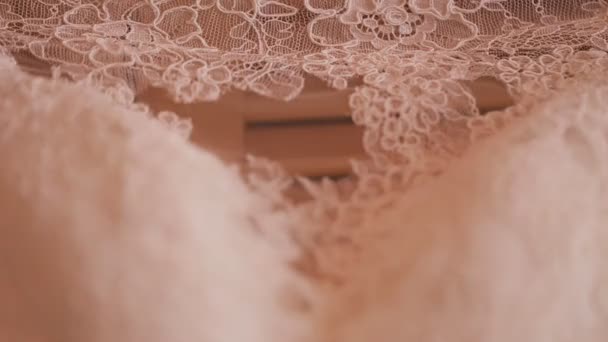 Close up of wedding cloth with lace. Wedding preparation. Wedding dress on hanger — Stock Video