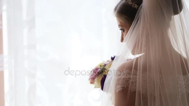 花の花束の臭いがする高級ウェディング ドレスの美しい花嫁。背面図 — ストック動画