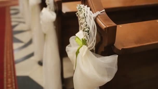 Grinalda de casamento no banco da igreja na cerimônia de casamento — Vídeo de Stock