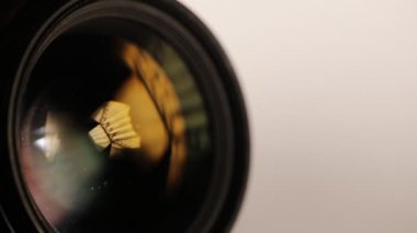 Kamera objektifi kalem fırça ile temizliyor. Yakın çekim. Makro