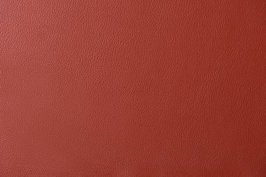 Kırmızı deri bir swatch bir bölümünün yakın genelinde tahıl ve ışık mili gösteren