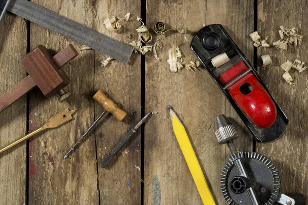 Old woodworking tools. Tools include a bradle, punch, gauge, ruler, drill and drill bit an auger and wood plane