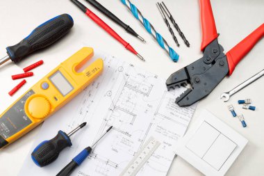 Multimetre, tornavidalar, tel kesiciler, matkap uçları, anahtarlar ve soketler dahil olmak üzere çeşitli elektrikli aletler ve bileşenler.