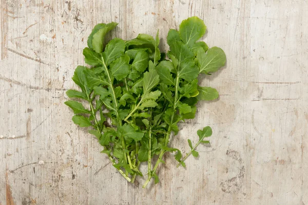 Bunch of Salad Greens on a Wooden Surface — Stock Photo, Image