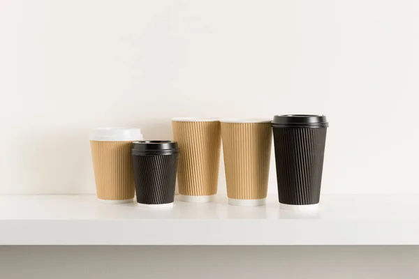 stock image Brown and Black Hot Drink Paper Cups on Shelf