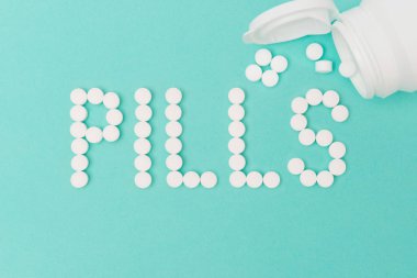 Bottle with Pills Forming the Word 'Pills'