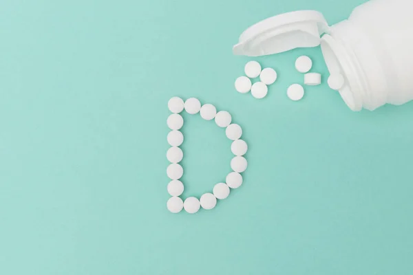 Bottle with Vitamin D Pills Forming the Letter 'D' — Stock fotografie