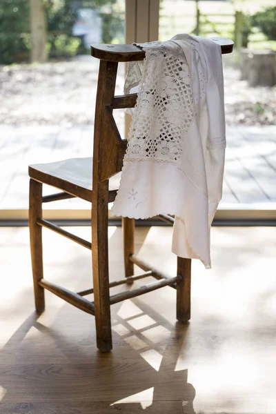 White Embroidered Cloth Hanging on a Wooden Chair Backrest — Stock Photo, Image