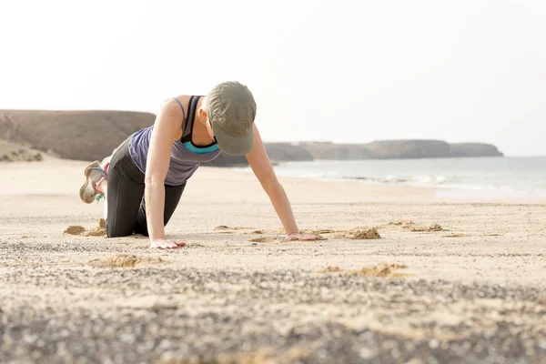 Fit Woman Doing Push-Ups By the Beach