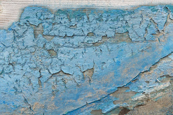 Nahaufnahme von getrockneter blauer Farbe auf Holz — Stockfoto