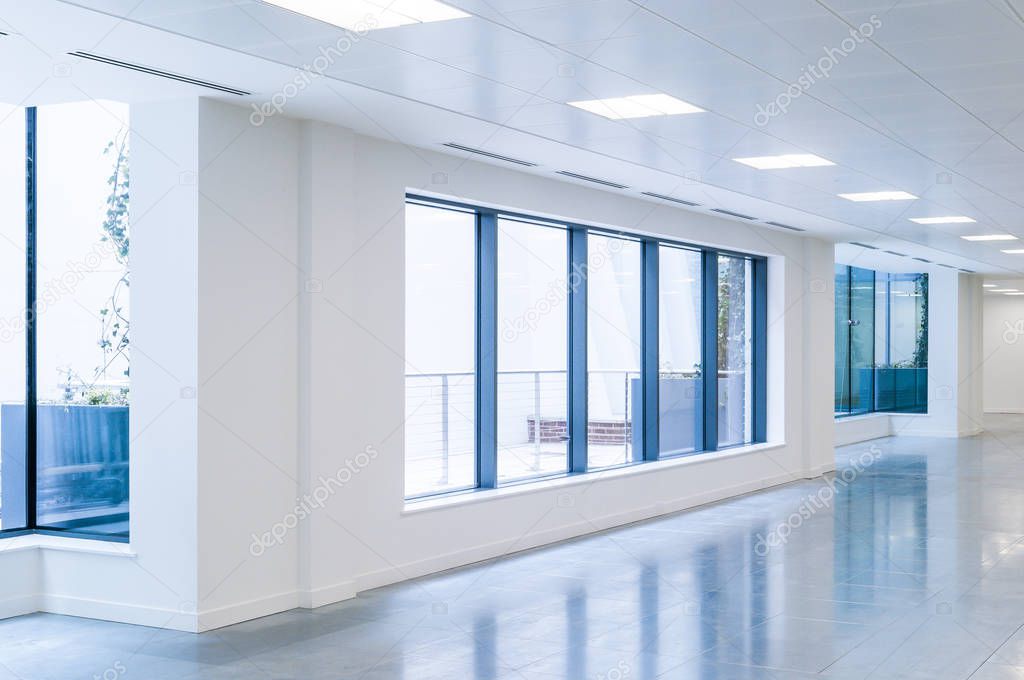 Wide angle view of an empty office wall with windows