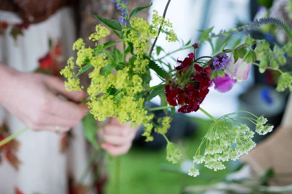 Florist Making a Posy Out of Assorted Flowers