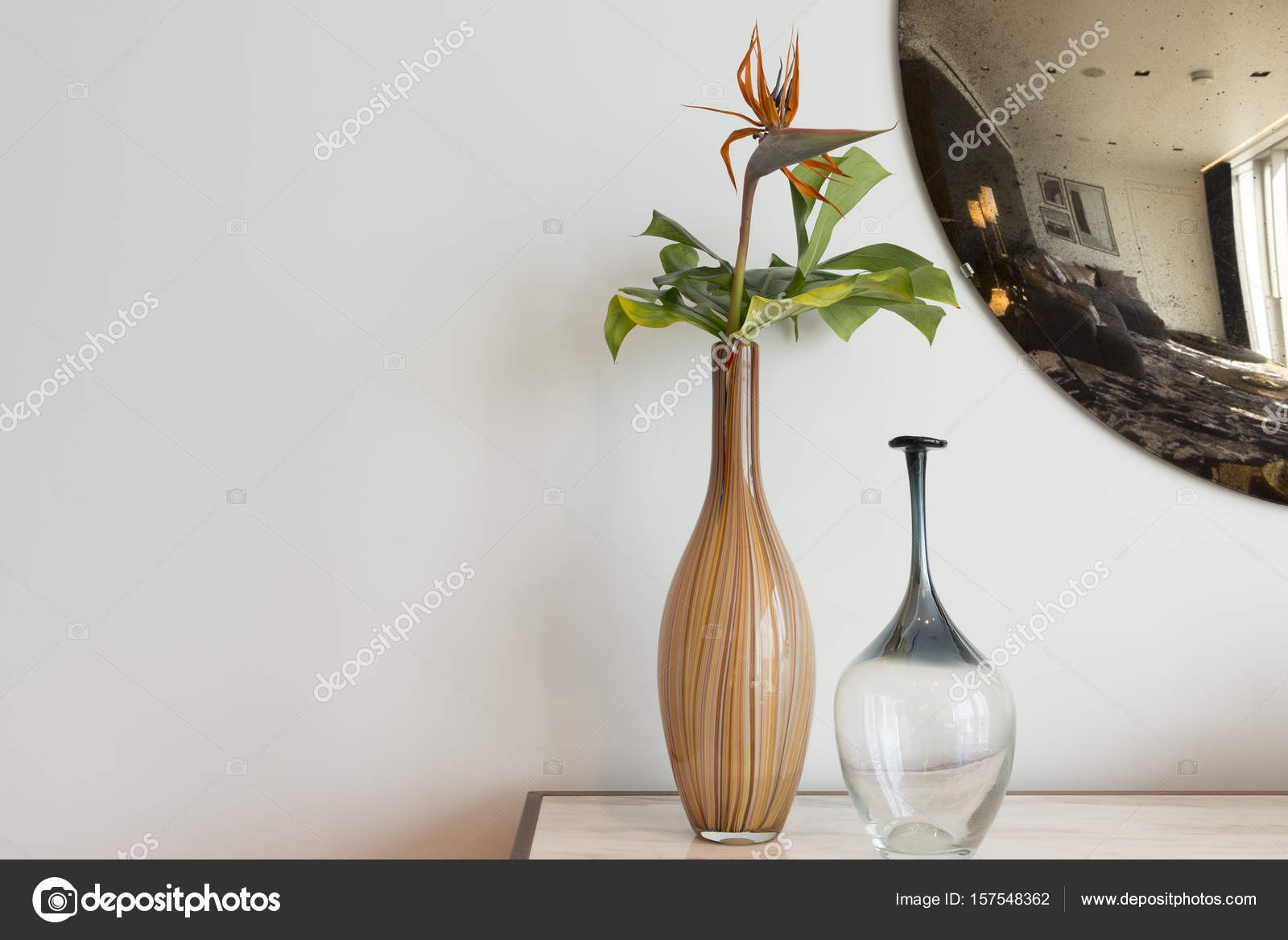 Decorative Vases On Table With Circular Mirror In Background Cop