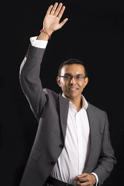 Young Man in Office Attire Raising or Waving His Right Hand