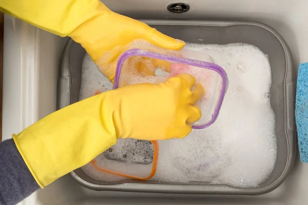 Пластиковые пищевые контейнеры мыли мыльной водой в кухонной раковине — стоковое фото