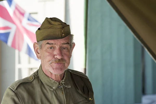 Armed Forces Veteran in Uniform with British Flag in Background