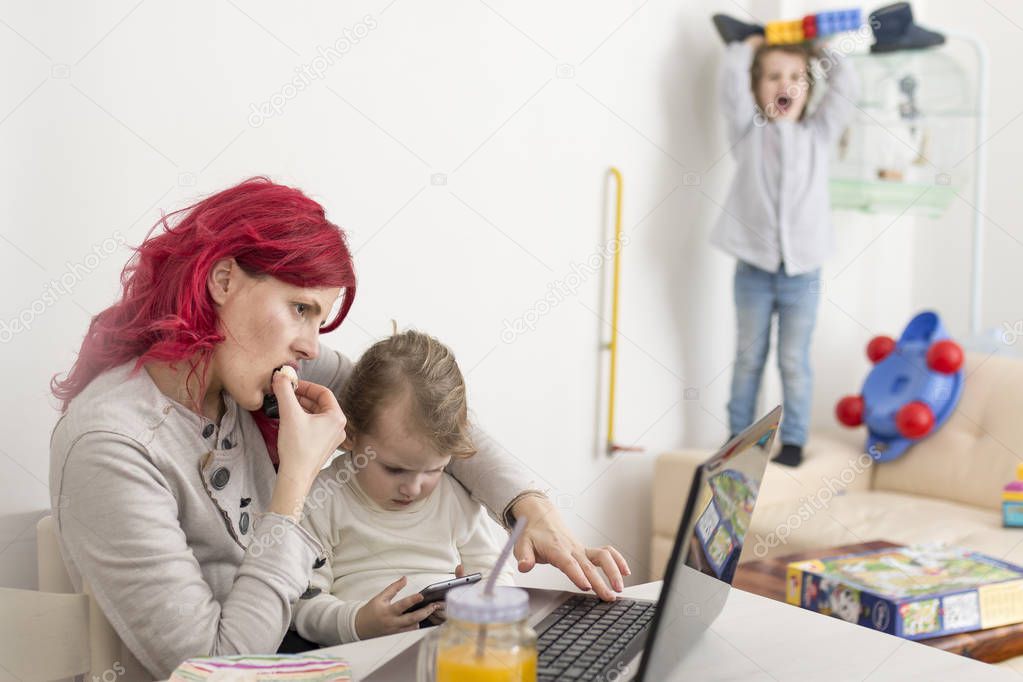 Busy Mom Working at Home with Kids Playing