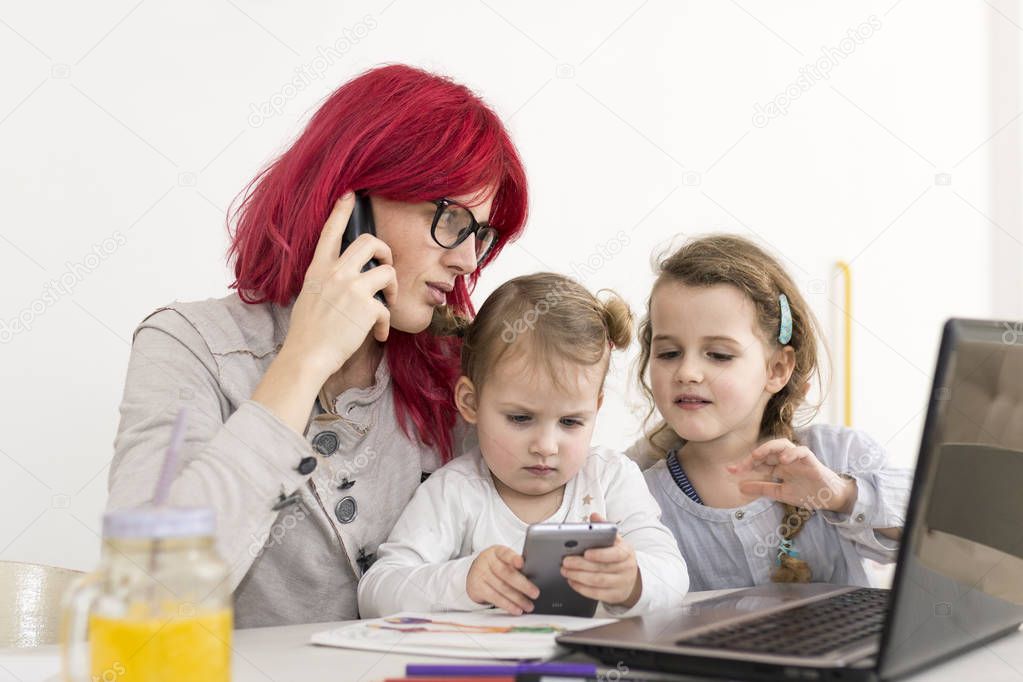 Work-From-Home Mom Talking on the Phone with Kids Playing with S