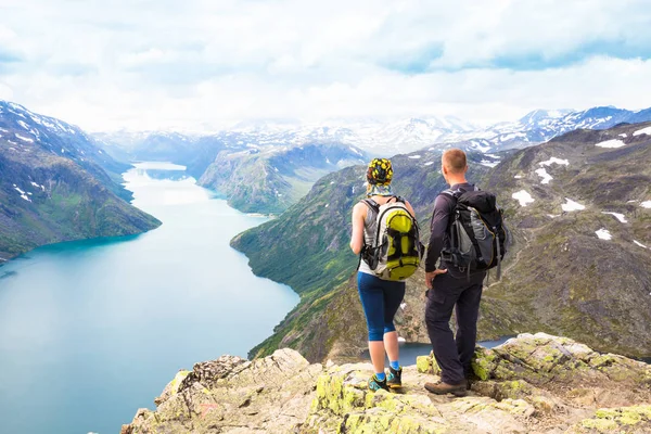 Esporte casal caminhadas em Besseggen. Caminhantes desfrutar de belo lago e bom tempo na Noruega . — Fotografia de Stock