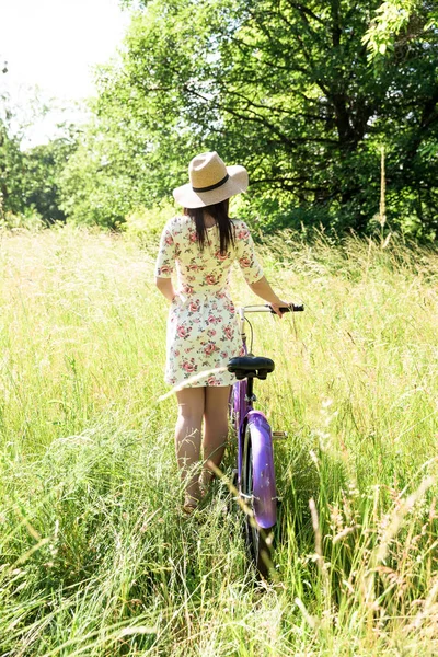 Happy pretty young girl bicycling on summer park. Happy relax time in city. Beautiful woman, sunny day — Stock Photo, Image