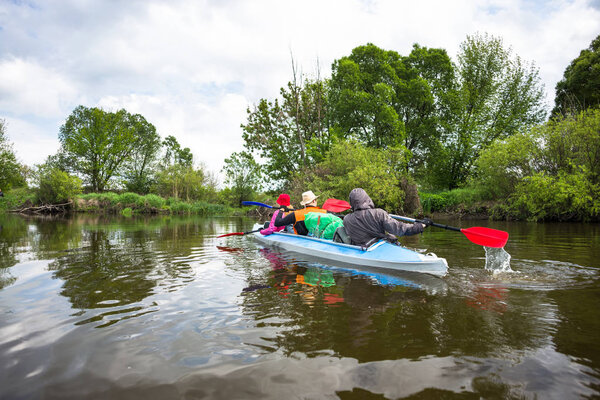 Kayaking on beautiful nature at summer sunny day. Sport people having fun