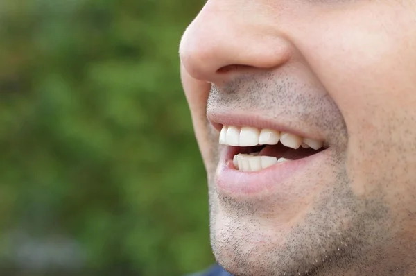 Beautiful wide smile of young man with healthy white teeth