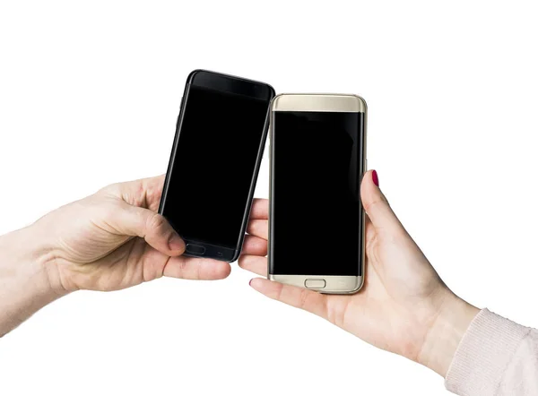 Goud en zwart slimme telefoons met met leeg blauw scherm kopiëren ruimte in vrouwelijke menselijke hand geïsoleerd op witte achtergrond Rechtenvrije Stockfoto's