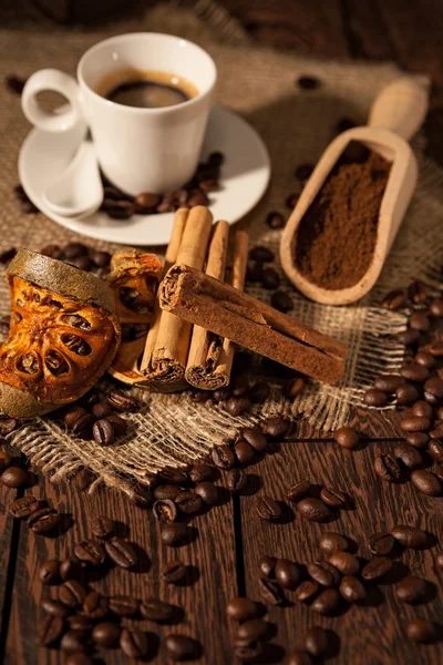 Cup of coffee with cinnamon and dried orange fruit — Stock Photo, Image