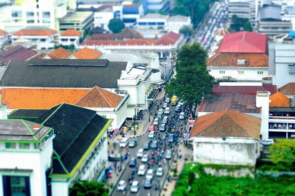 Busy hour in Asia Afrika Street, in Bandung, Indonesia. With many motorcycles and cars in the road, seen from top, tilt shift. 5 March 2016